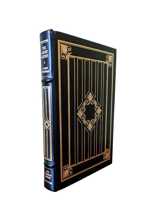 Black leather-bound edition of 'The Great Gatsby' by F. Scott Fitzgerald, featuring gold leaf detailing and a ribbon bookmark sold at Kadri Books